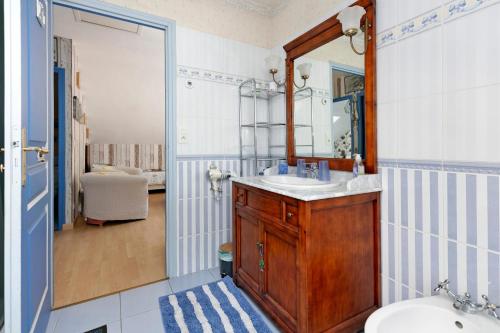 a bathroom with a sink and a mirror at Chez Anne-Marie et Constant in Pornichet