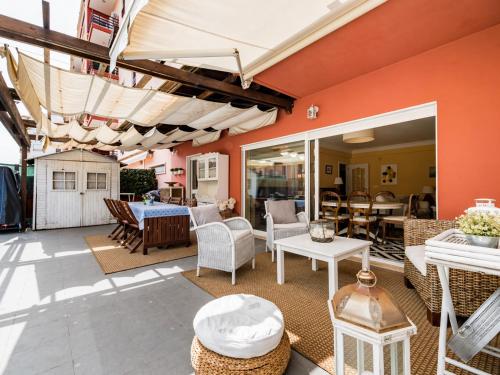 a patio with a table and chairs and an umbrella at Lisbon Coast, 3 bedroom apartment with large terrace in Linda-a-Velha