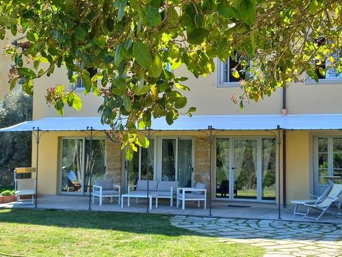 a house with glass doors and white chairs at Fattoria di Maiano in Fiesole