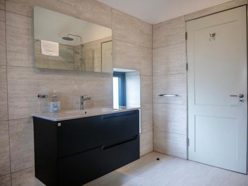 a bathroom with a sink and a mirror at Country Setting in the Middle of Dingle Town. in Dingle