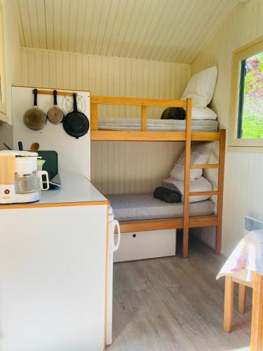 a small room with two bunk beds in a house at Camping Le Vert-Bois - Corrèze in Saint-Martin-la-Méanne