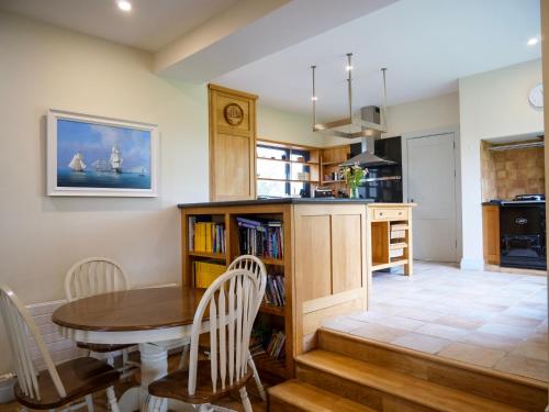 a kitchen and dining room with a table and chairs at Country Setting in the Middle of Dingle Town. in Dingle