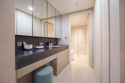 a bathroom with a sink and a mirror at The First Clark Hotel and Residence in Pampang
