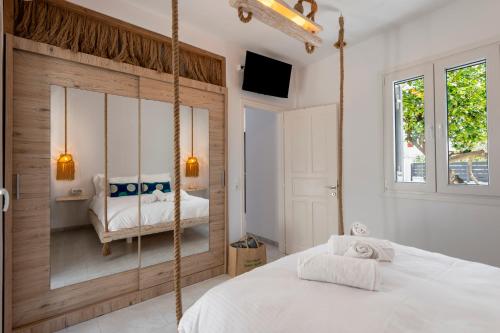 a bedroom with a swinging bed and a window at Zen Milos Green Apple in Pollonia