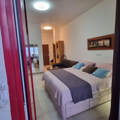 a bedroom with a large bed with blue pillows at Favola Marina in Scalea