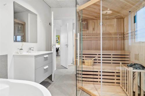 a bathroom with a sink and a glass shower at 30441-Odder-Strandvaenget-12 in Odder