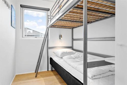 a bedroom with a bunk bed and a window at 30441-Odder-Strandvaenget-12 in Odder