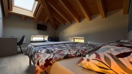 a bedroom with a bed with a comforter and a window at Ca' Giulia in Rigoso