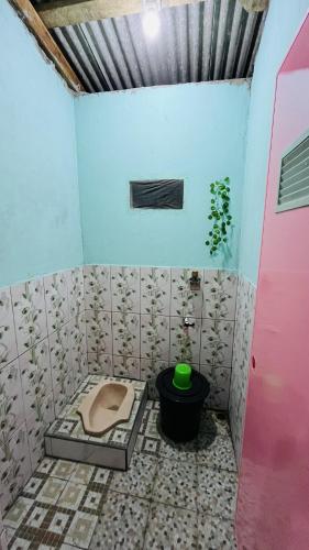 a bathroom with a toilet in a room at Bintang Sawarna 2 By ARBA in Sawarna