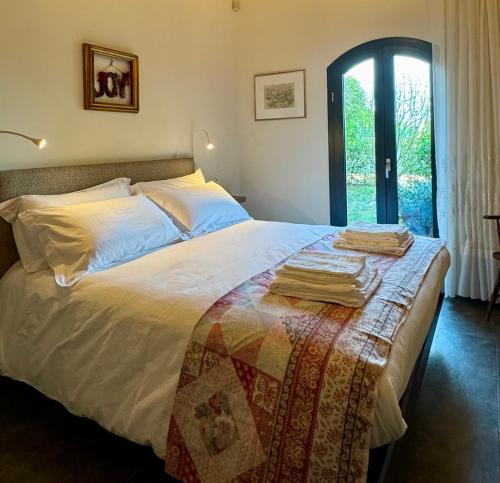 a bedroom with a bed with a quilt on it at Casa Barovaldo in Zola Predosa