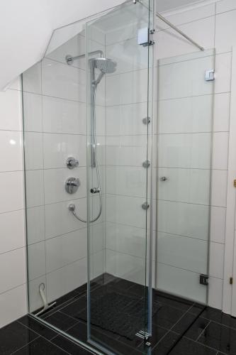 a shower with a glass door in a bathroom at Ferienwohnungen Tarmann in Bodensdorf
