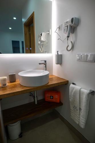 a bathroom with a white sink and a mirror at Casa da Pegada in Macedo de Cavaleiros