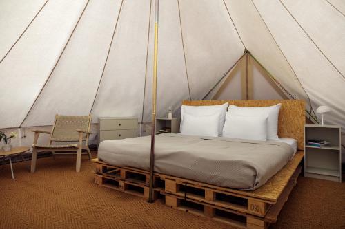 a bedroom with a bed in a tent at Glamping pospolu in Mokrovraty