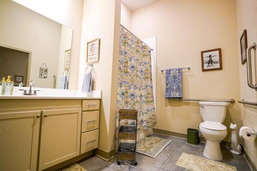 a bathroom with a toilet and a sink and a shower at Ruby Suite - New 2 bdrm 2bath near Mass! in Lawrence