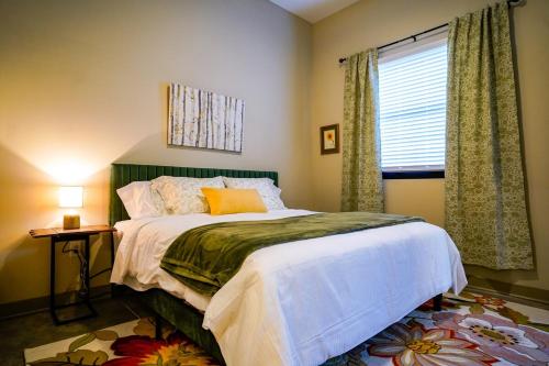 a bedroom with a large bed and a window at Ruby Suite - New 2 bdrm 2bath near Mass! in Lawrence