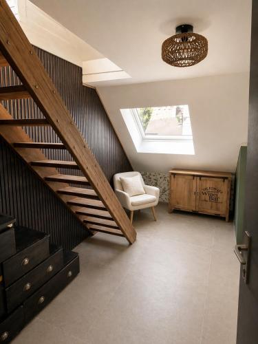 a living room with a staircase and a chair at Vaerthof in Diepenbeek