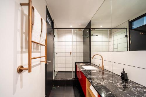 a bathroom with a sink and a shower at Crayfish Penthouse - The Onyx Cape Town in Cape Town