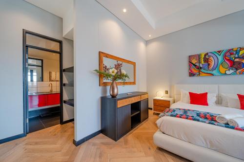 a bedroom with a king sized bed and a mirror at Crayfish Penthouse - The Onyx Cape Town in Cape Town