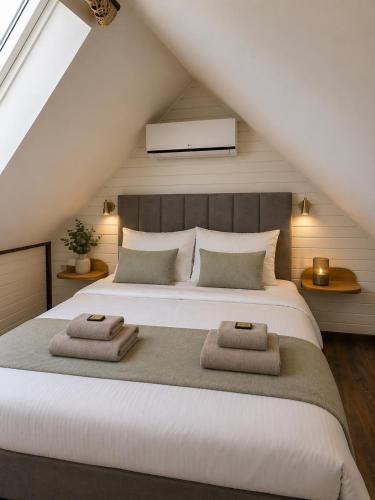 a bedroom with a large bed with two towels on it at Vaerthof in Diepenbeek