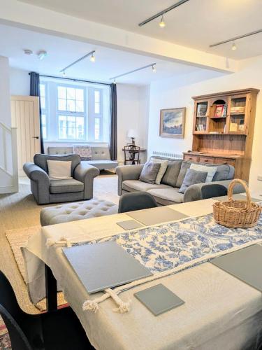a living room with couches and a table at The Old Post Office - Central Helmsley with Parking in Helmsley