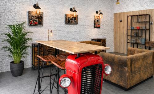 a restaurant with a table with a red radiatoritures at Magnolia Suites & Stays in Porto