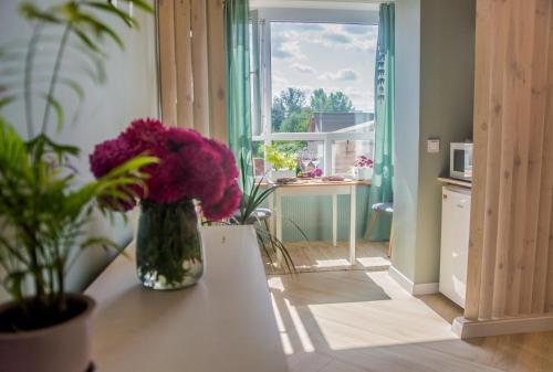 a vase of purple flowers on a table in a kitchen at Kolo in Boryspil
