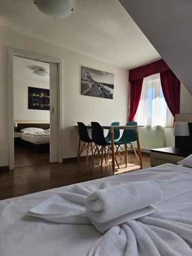 a bedroom with a bed and a table and chairs at Residence Vysta in Prague