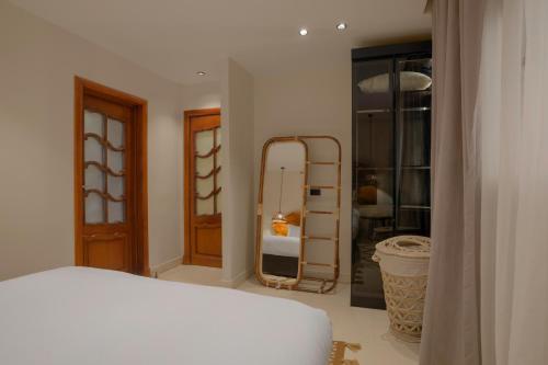a bedroom with a white bed and a mirror at M-Residence By Brassbell in Cairo