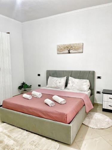 a bedroom with a bed with two towels on it at Dreamy Heaven Escape Villa in Shijak