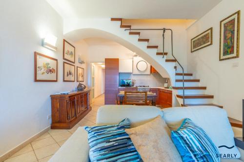 a living room with a couch and a staircase at Casa Solea in Olbia