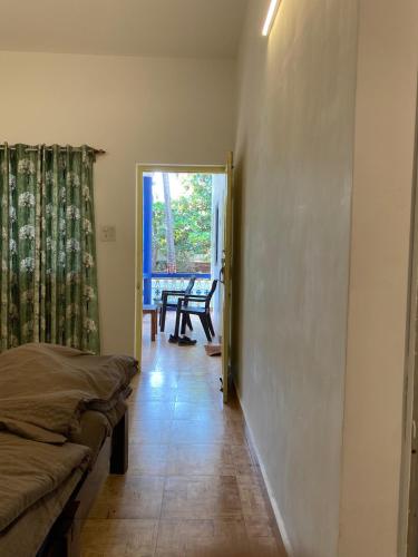 a room with a hallway with a bed and a table at Anthony Stays Anjuna in Anjuna