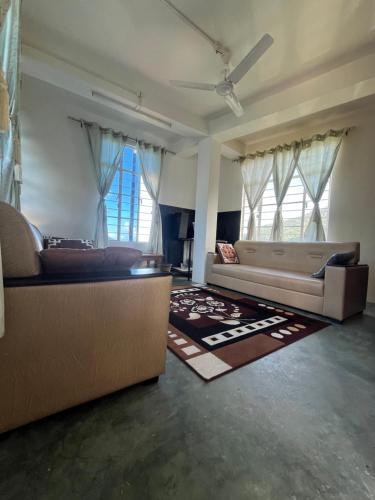 a large living room with two couches and a couch at Saus Home in Khonoma