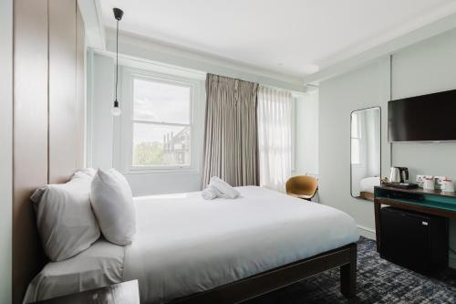 a hotel room with a bed and a window at The Lancaster Hotel in London
