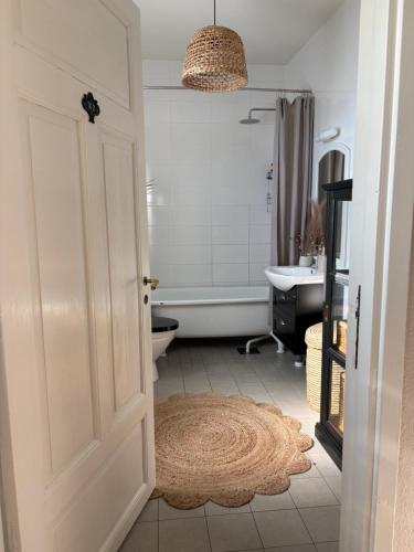 a bathroom with a toilet and a sink and a door at Villa Tornhaga in Oskarström