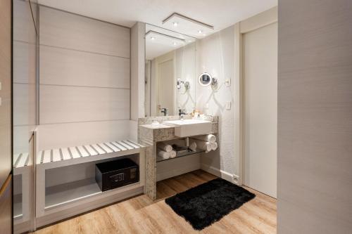 a bathroom with a sink and a mirror at Radisson Hotel Curitiba in Curitiba