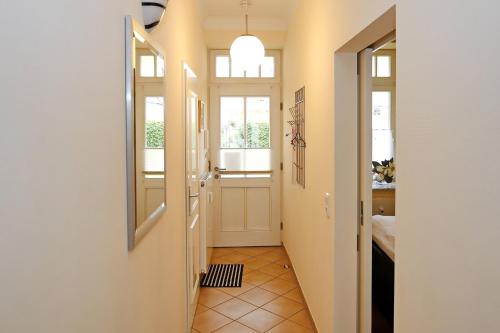 a hallway with a door and windows in a house at Dünenschloss Wohnung 1-05 in Kühlungsborn