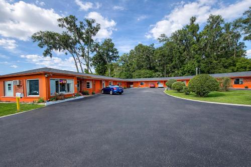 an empty parking lot in front of a motel at Stevens Motel by Capital O Ocala US 27 in Ocala