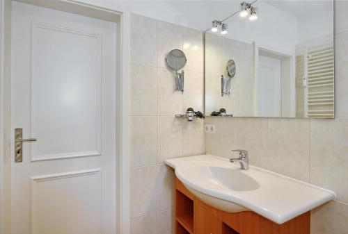 a bathroom with a sink and a mirror at Dünenschloss Wohnung 4-11 in Kühlungsborn
