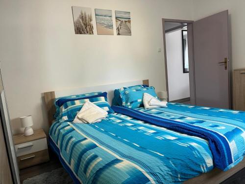 a bedroom with two beds with blue sheets at Apartment Boro in Selce