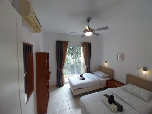 a hotel room with two beds and a window at Comfortable and Ideally Situated in Paphos