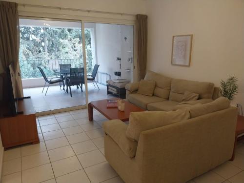 a living room with a couch and a table at Comfortable and Ideally Situated in Paphos