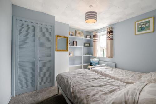 a bedroom with two beds and a book shelf at 2 Bed in Heacham oc-p29546 in Heacham