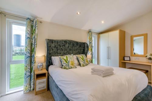 a bedroom with a large bed with a large window at Field View 1 bed-No Pets- Walnut in Eye