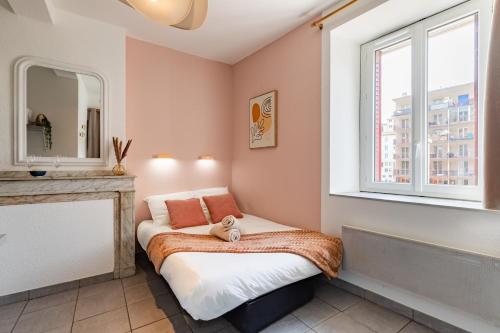 a small bedroom with a bed and a window at Le Colibri in Foix