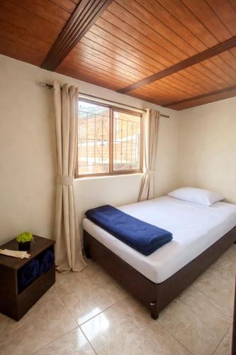 a bedroom with a large bed with a window at Salento verde in Salento