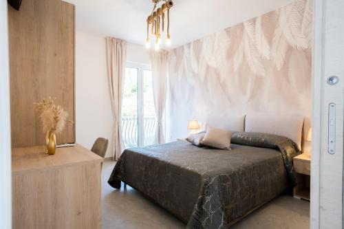 a bedroom with a large bed and a window at Villa Rossa in Agerola