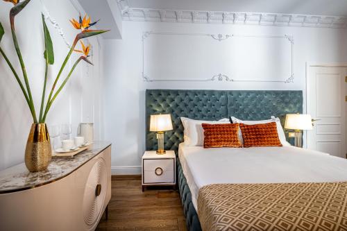 a bedroom with a large bed with a blue headboard at Gold Artè Collection in Florence