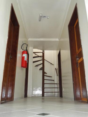 a room with a fire extinguisher hanging on the wall at Pousada Suítes Do Pelô in Salvador