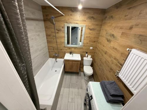 a bathroom with a tub and a toilet and a sink at 2 кім кв BIG APARTMENT TOP Center in Sumy