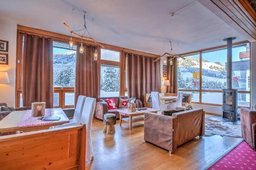 a living room with a table and chairs at Hotel Relais Alpin in Les Mosses